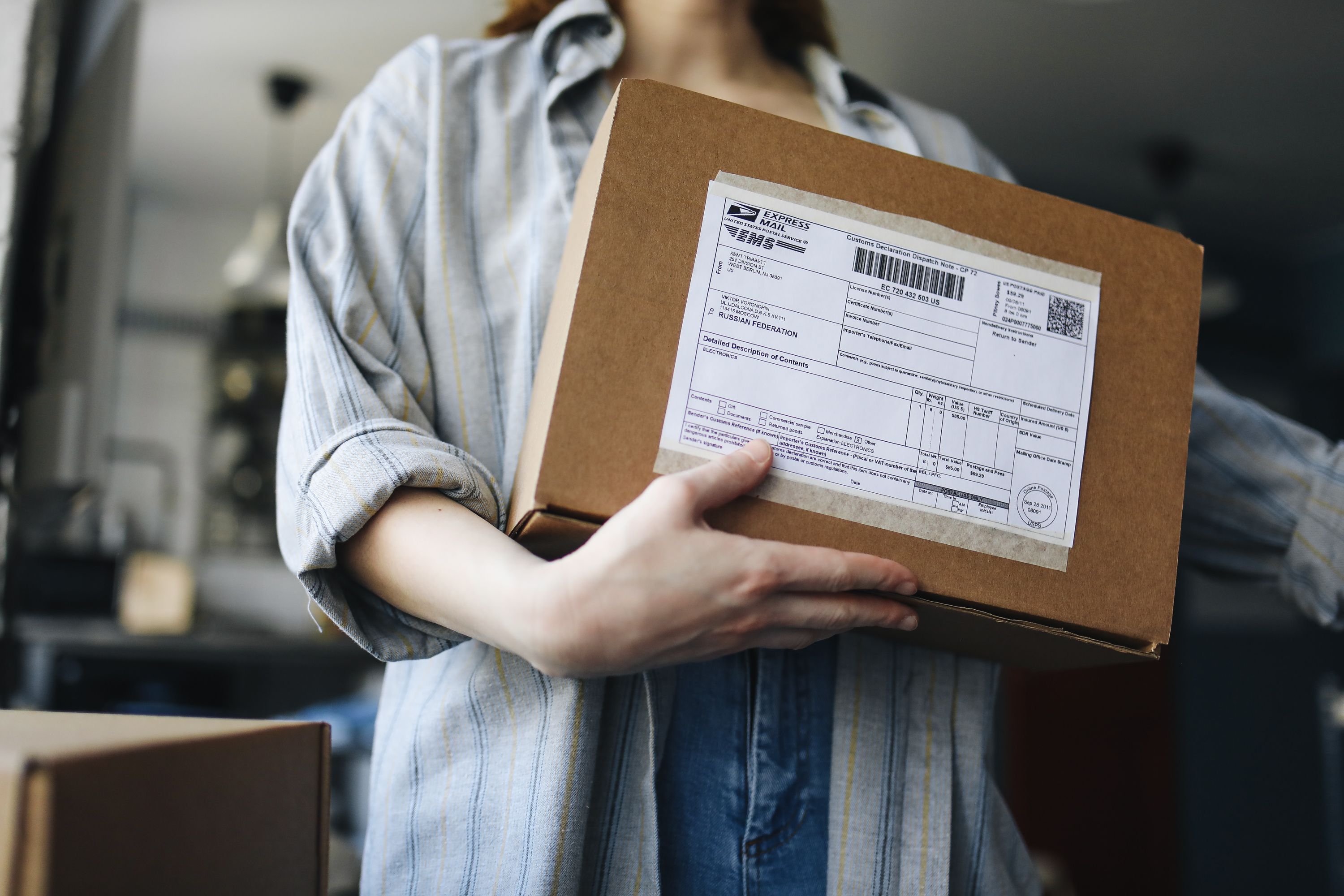 A business owner preparing a physical product for shipping
